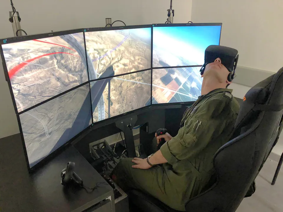 Trainee in a VR headset at a training station